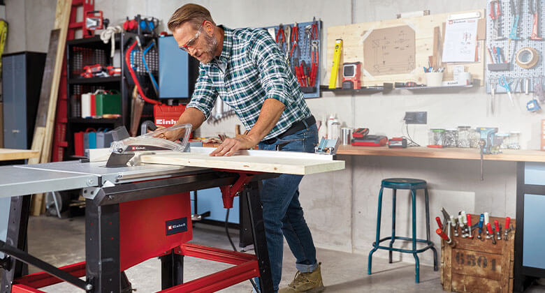 Man using a table saw for sawing wood